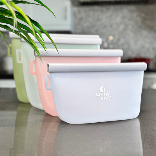 Set of silicone food storage containers on a kitchen counter with 'Livia Vibe' branding.